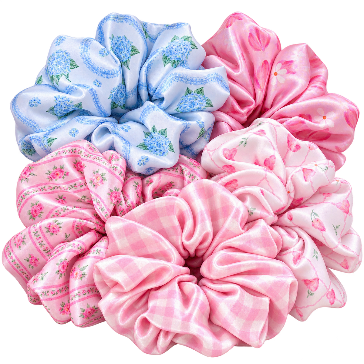 Five Silk hair scrunchies arranged together on a white background, featuring different patterns: blue floral print, pink cherry print, pink gingham, and pink floral print.