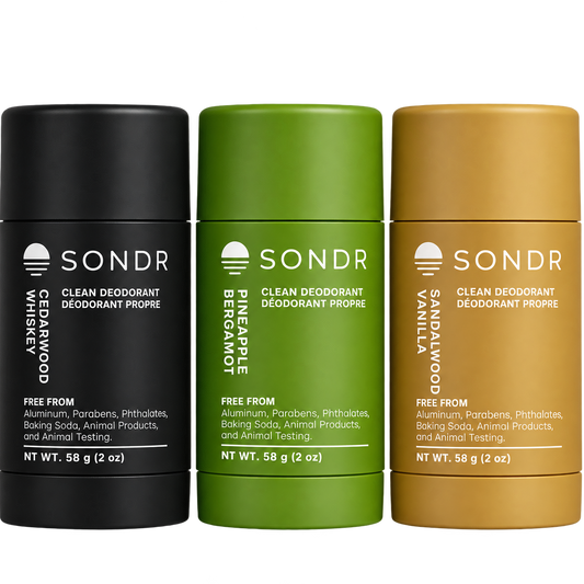 Three SONDR Clean Deodorant Deodorant Propylene sticks in black, green, and tan packaging, labeled Cedarswood Whiskey, Bergamot, and Sandalwood Vanilla.