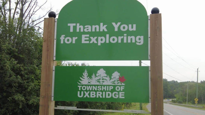 Thank You for Exploring and TOWNSHIP OF UXBRIDGE with trees and a road in the background.